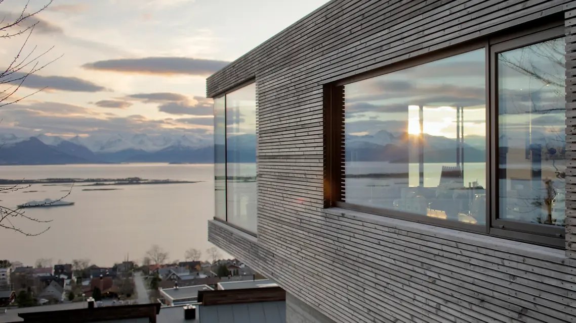 Contemporary aluminium window framing a coastal landscape